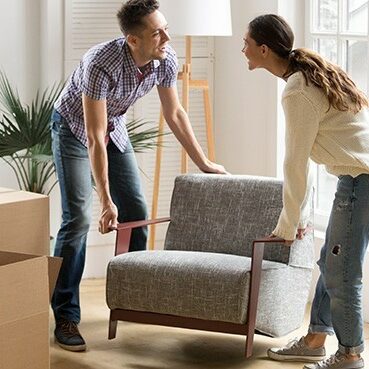 Couple moving sofa | Carpet Plus