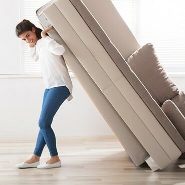 Woman moving sofa | Carpet Plus